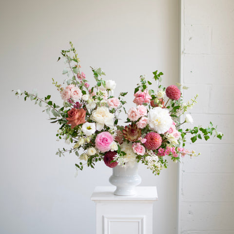 Elegant Sympathy Urn overflowing with gorgeous flowers and greenery.