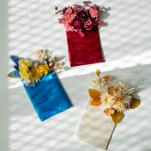 Three pocket boutonnieres in differing colour palettes. 