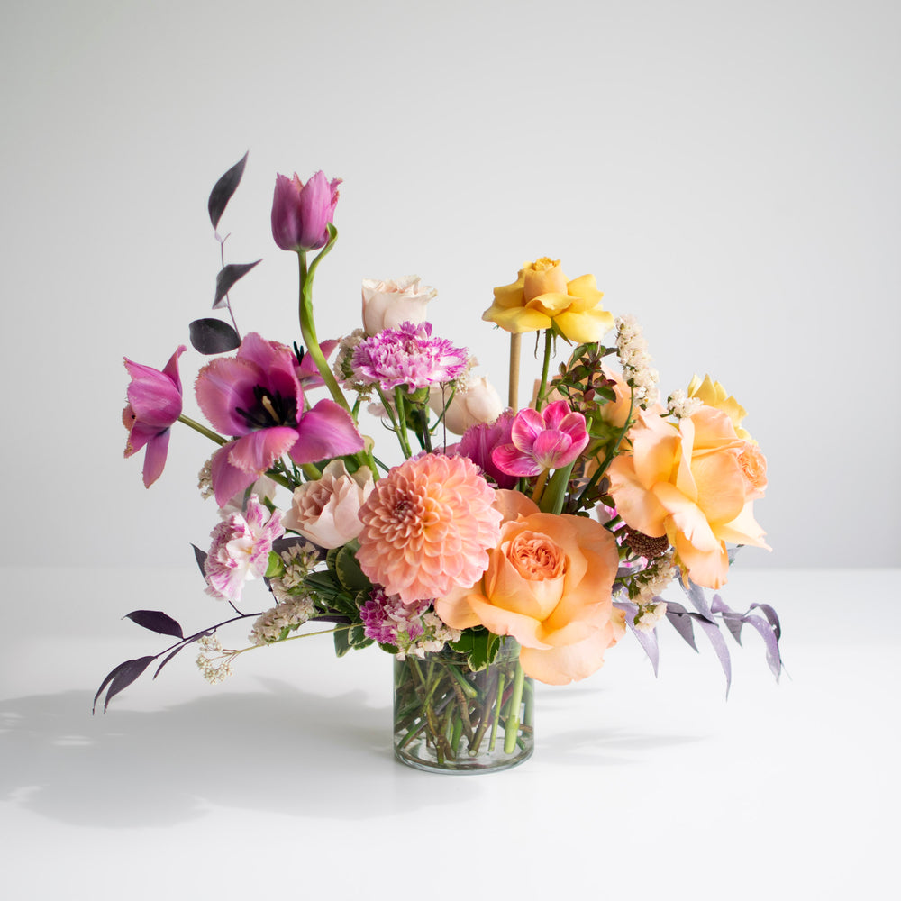 A pink, yellow, and orange pastel gradient floral arrangement.