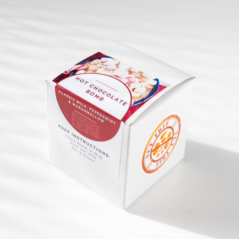 A nut free peppermint hot chocolate bomb with red and white packaging.