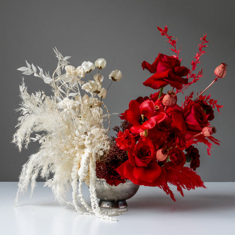 A large, split palette floral arrangement. The left side is snow white, while the other is deep red.