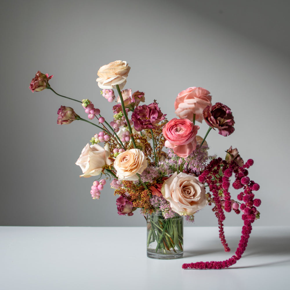 A moody, neutral pink flower arrangement with amaranthus and ranunculus.
