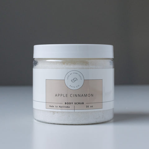 Apple Cinnamon scented body scrub in a clear plastic container.