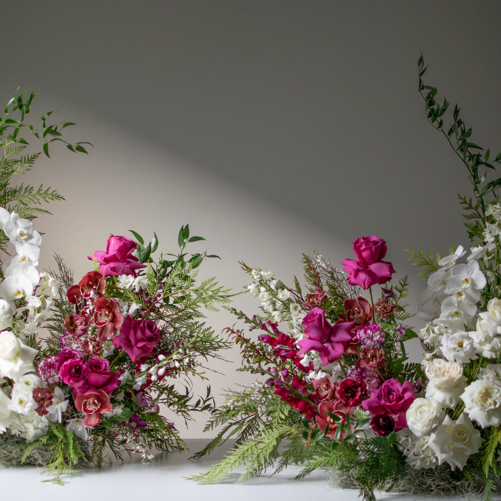 Two large split palette floral arrangement for weddings side by side with whites and rich jewel tones.