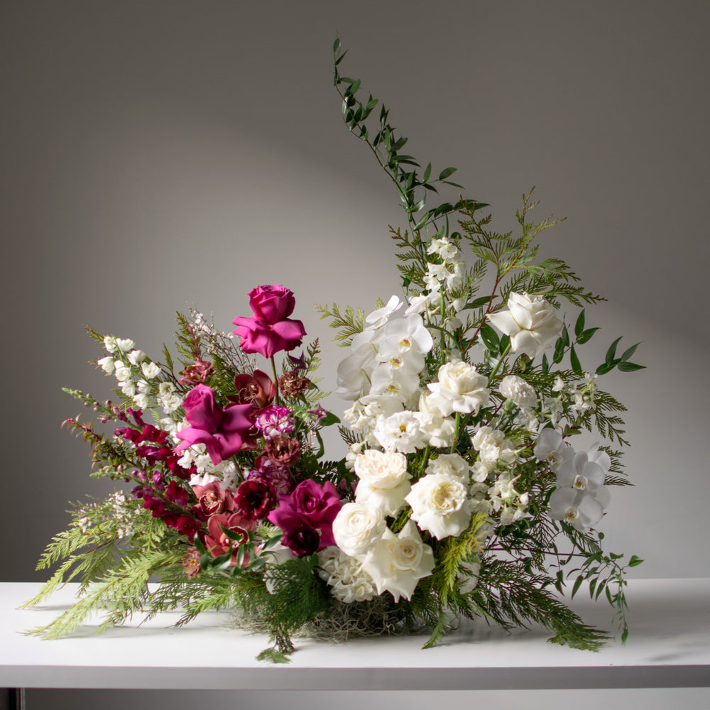 Stunning large split palette floral arrangement for weddings with whites and rich jewel tones.