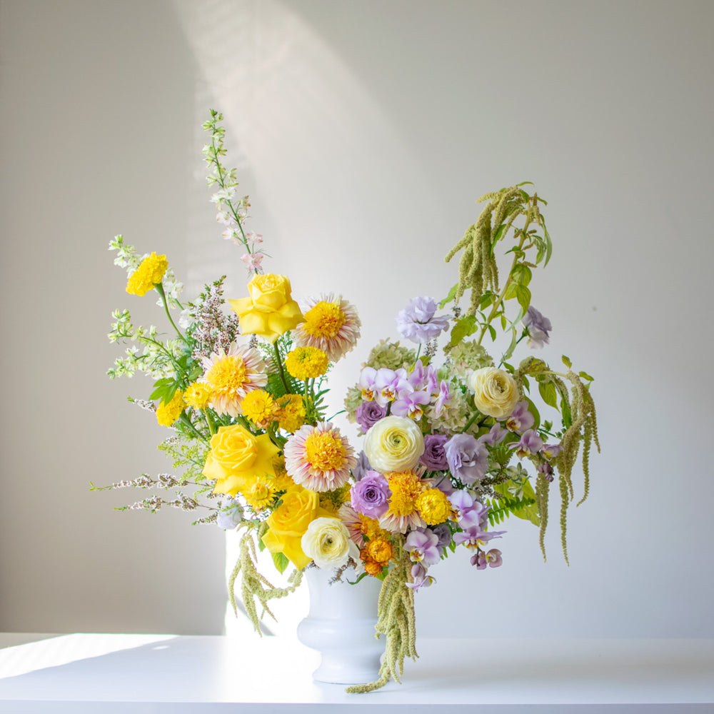 Sympathy Urn with a beautiful spring, colourful palette of yellows, pastel purples and greenery. 