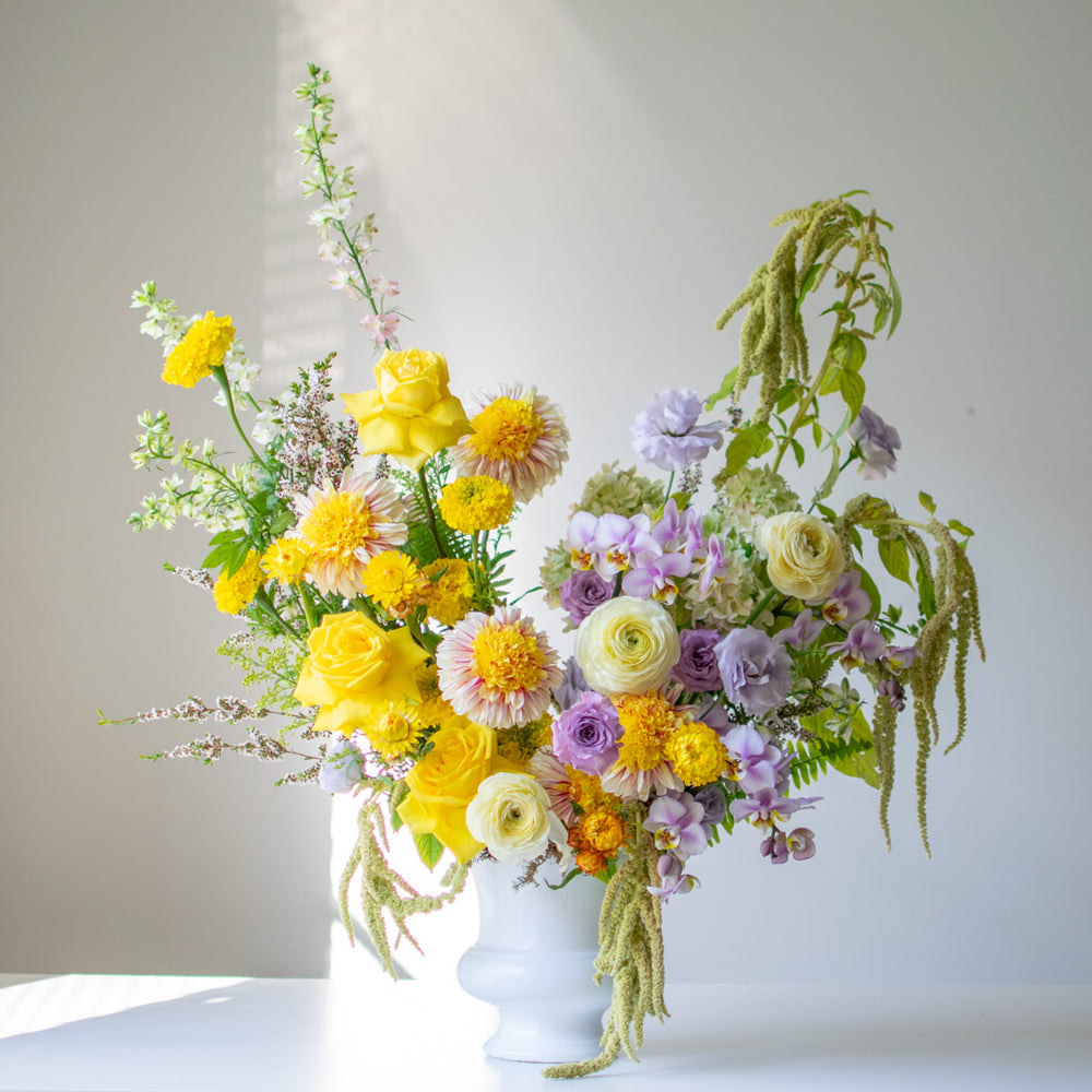 Sympathy Urn with a beautiful spring, colourful palette of yellows, pastel purples and greenery.
