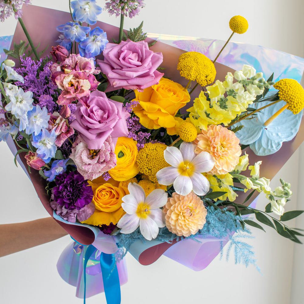 A large colourful bouquet with tulips, anthurium, dahlia and ranunculus.