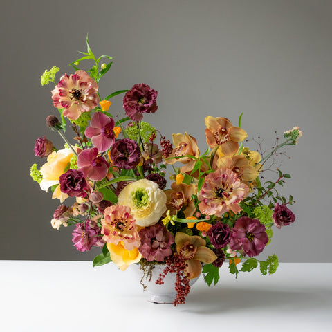Luscious fresh flower arrangement with yellow, burgundy and green palette.