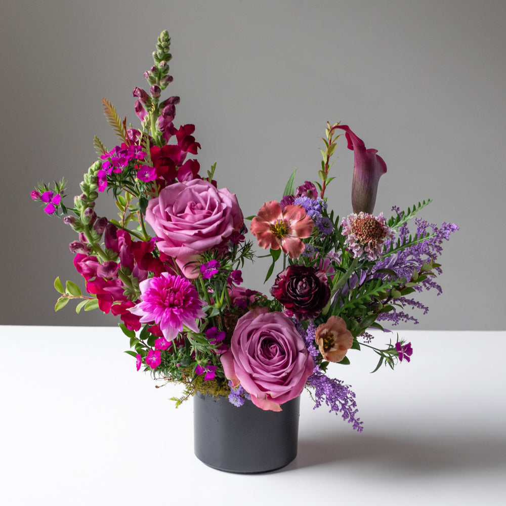 bold colour palette of pinks, fuschias, and purples with added greenery