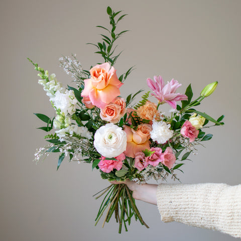 beautiful soft & subtle hand-tied arrangement with a pink, peach, and white colour palette