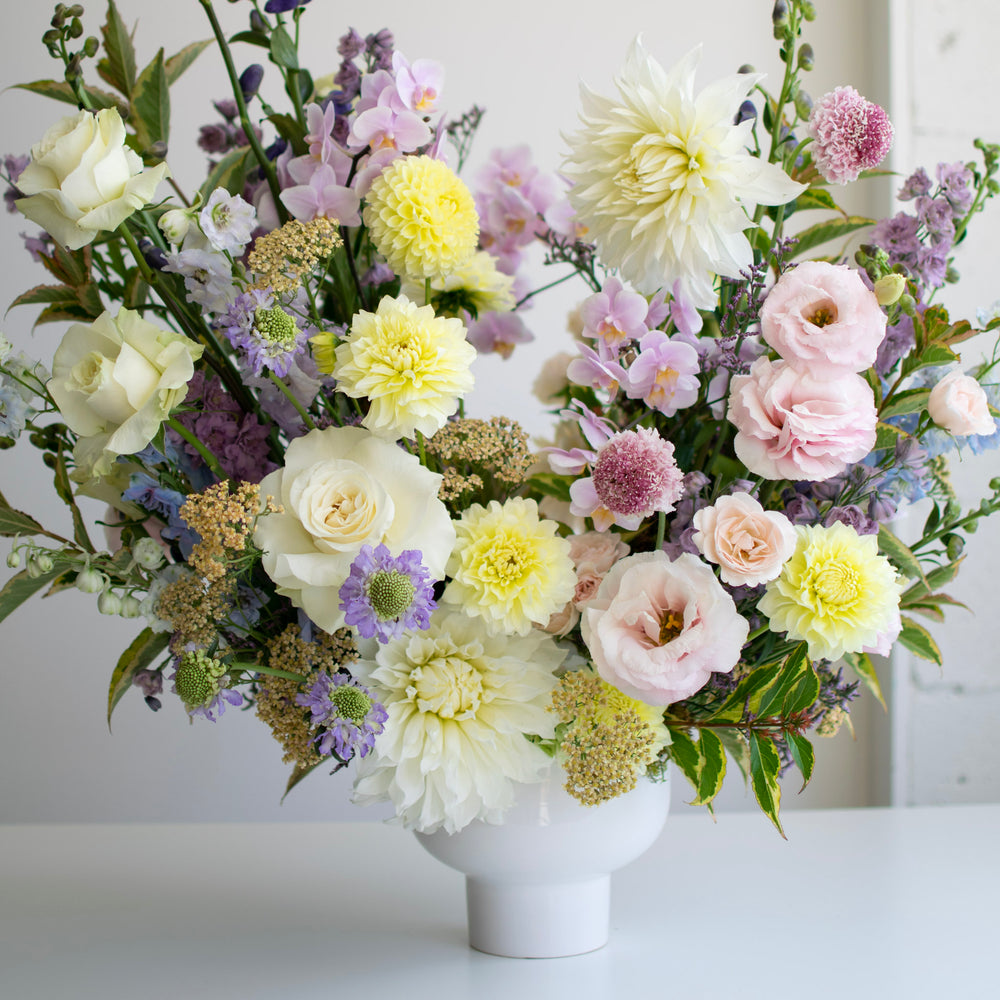 a gorgeous array of spring colors, soft pinks and yellows in a large flower arrangement