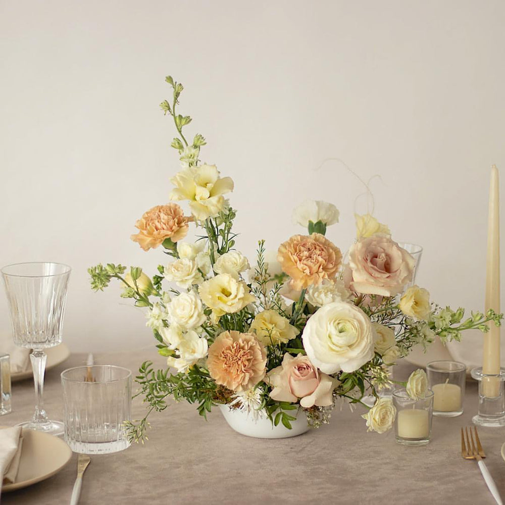 A large and classy floral centrepiece on a wedding tablescape.