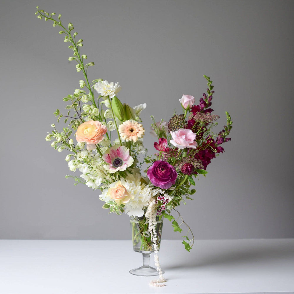 Our florist personal favourite would be this Standard Footed Glass Vase Arrangement.
